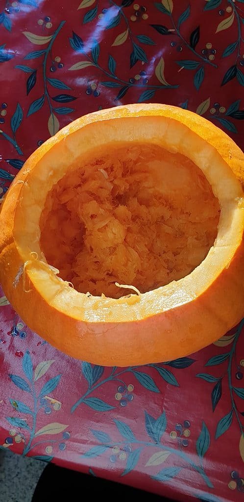 Partially hollowed out pumpkin with bits inside 1
