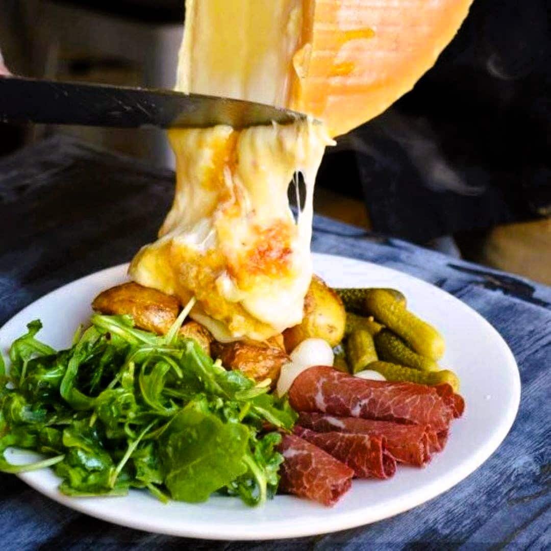 Raclette cheese onto veg and meat 71