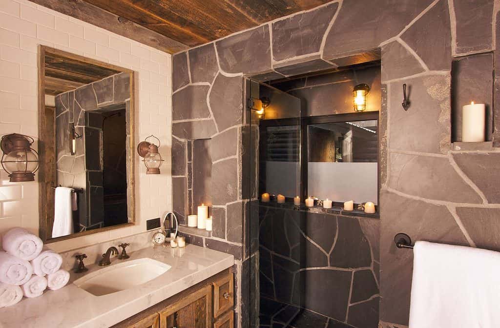 Rustic bathroom with stone wall and candles
